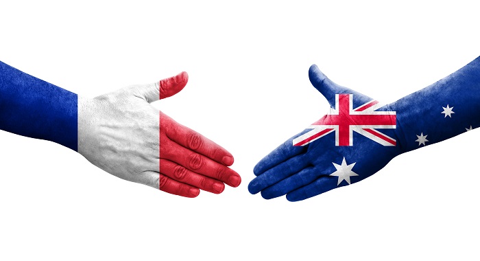 Graphic -Handshake between Australia and France flags painted on hands