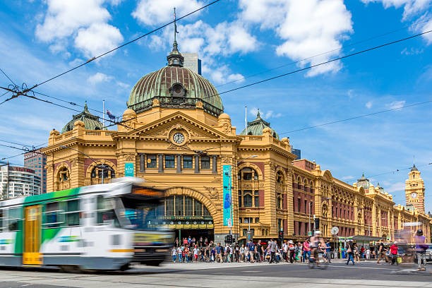 Photo of tram travelling past Flinders Street Station