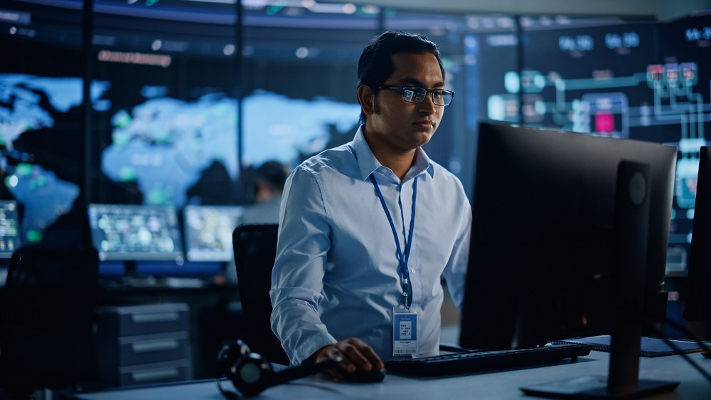 Photo of man at computer desk