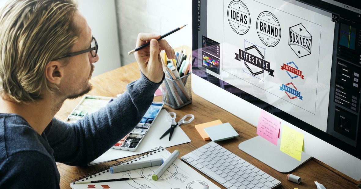 Graphic artist in front of computer working on branding