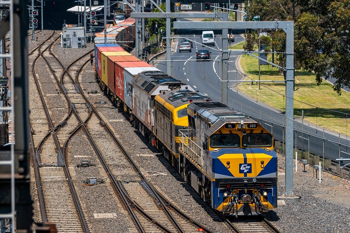 Freight train travelling through Melbourne suburbs