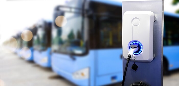 Photo of close up of electric bus charging up via power socket