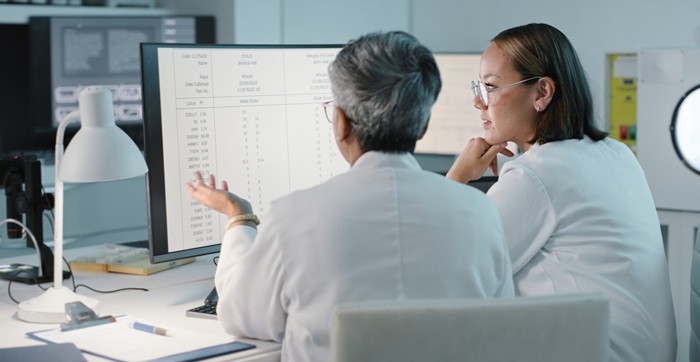 Medical women on computer for research, medical report in laboratory for analysis, results and bitoch article