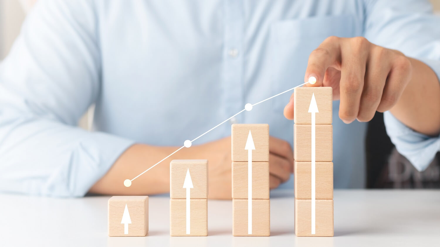 Business person using hand to highlight increased sales