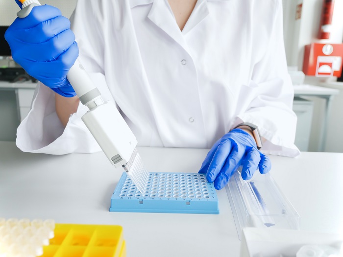 Scientist working with multichannel pipette