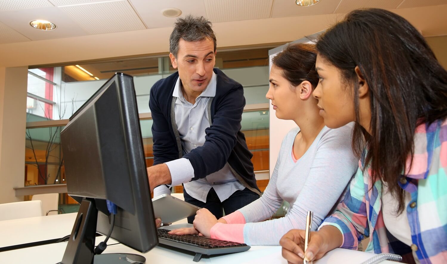 Trainer in front of computer training students